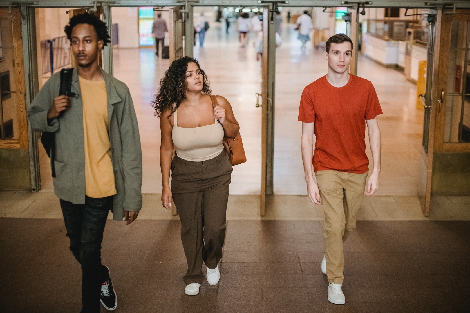Three people leaving a room