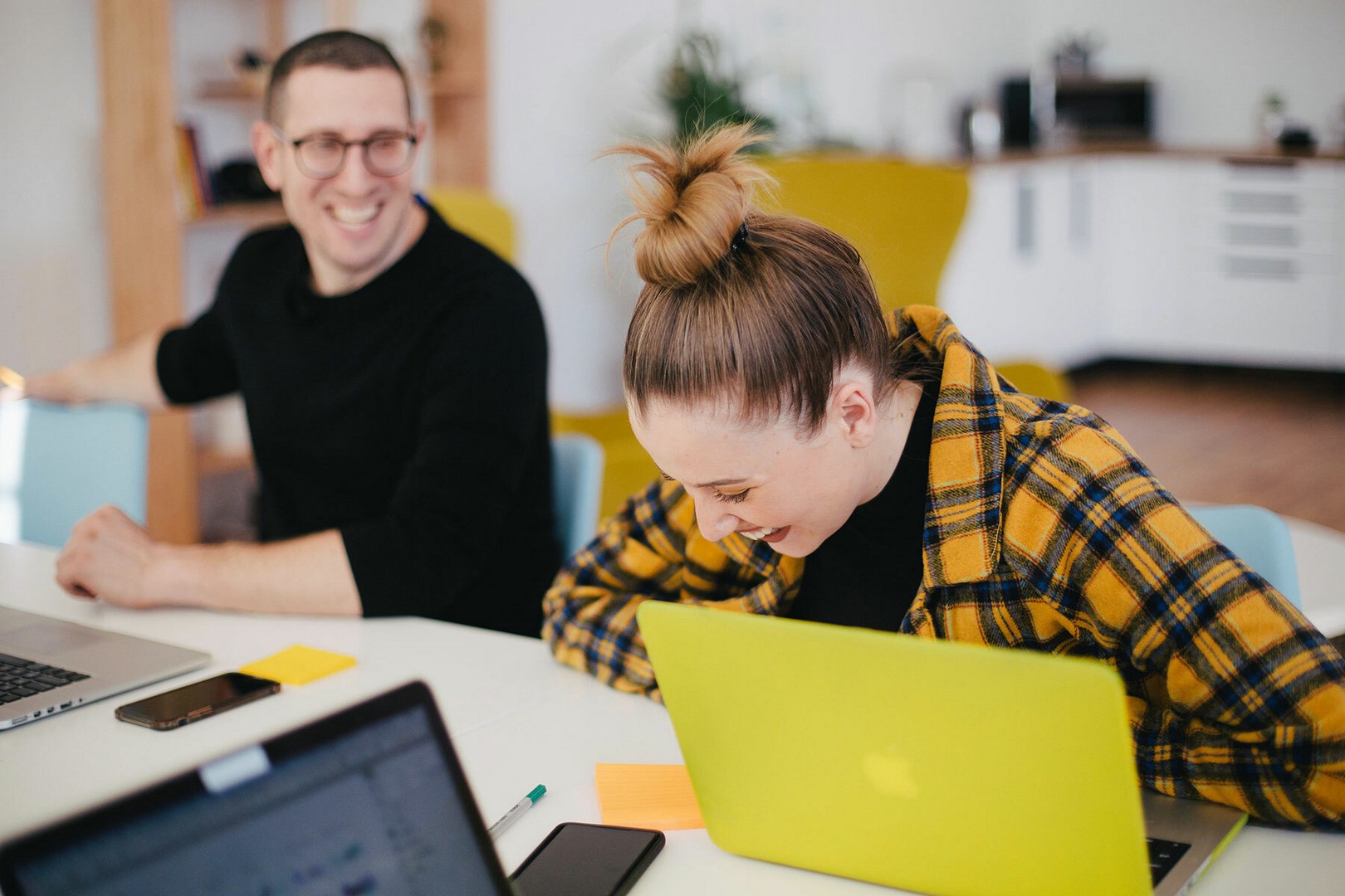 Two coworkers laughing together