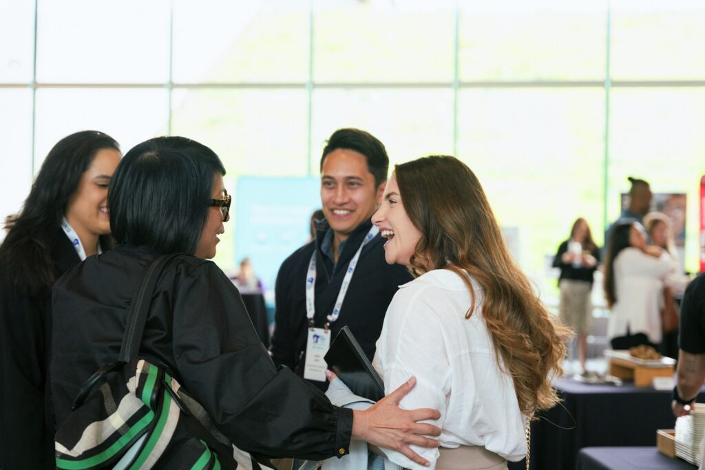 A group of peers talking and smiling at each other