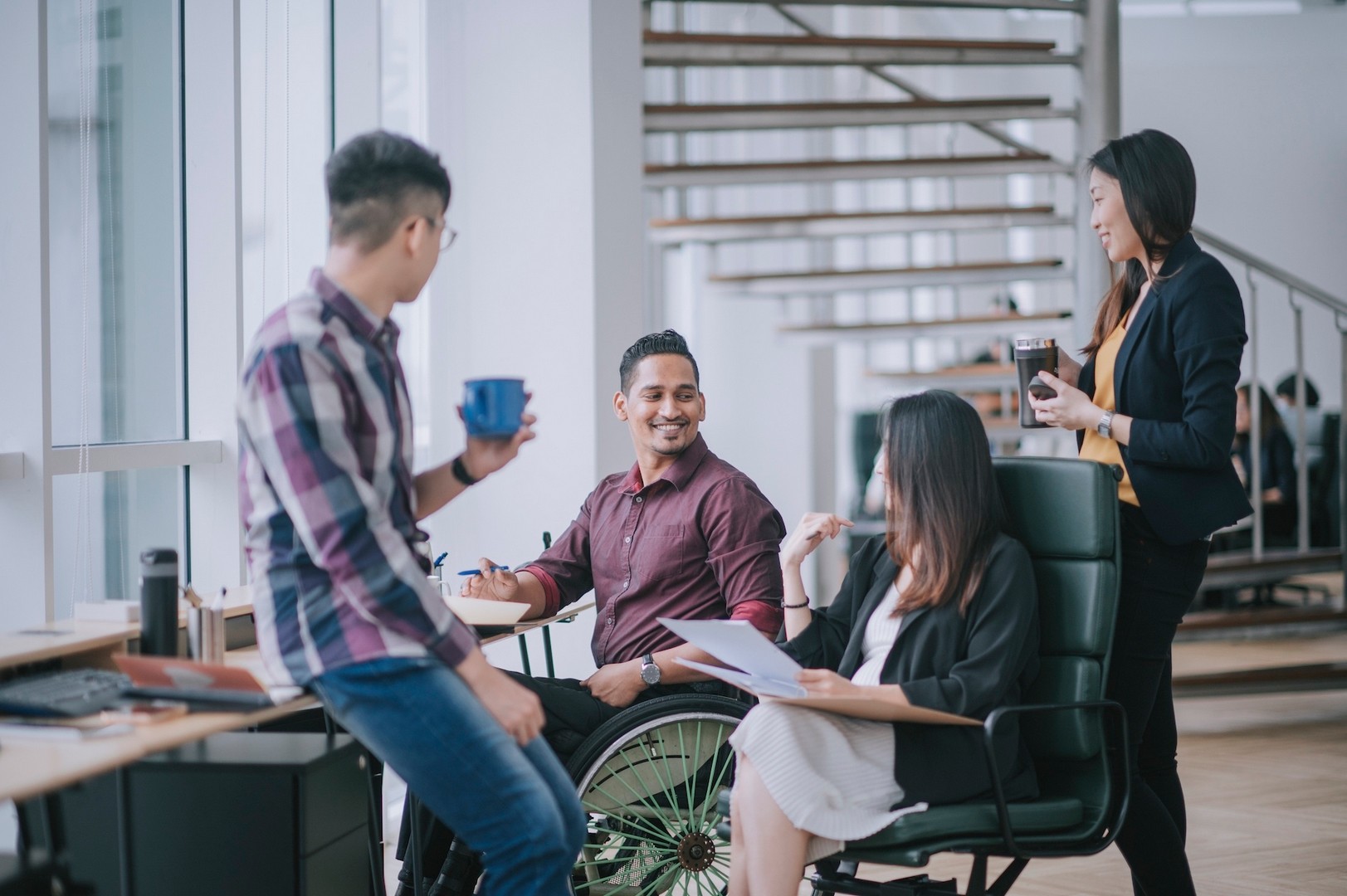 A group of peers talking and smiling at each other