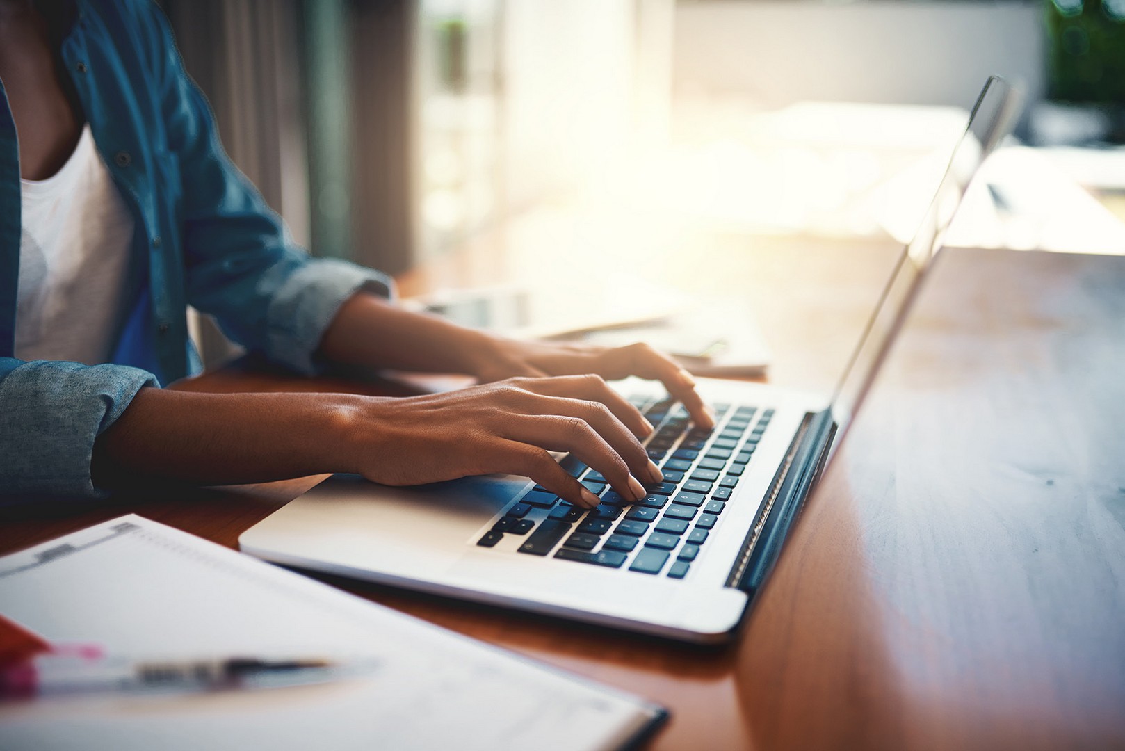 Person typing at a laptop