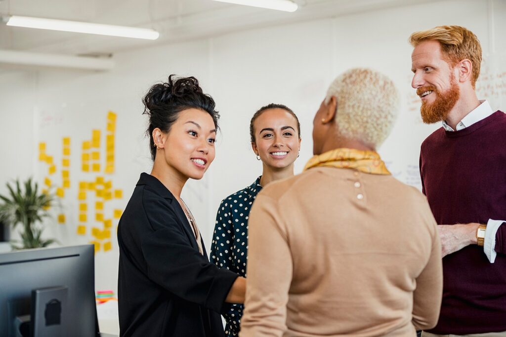 A group of peers talking and smiling