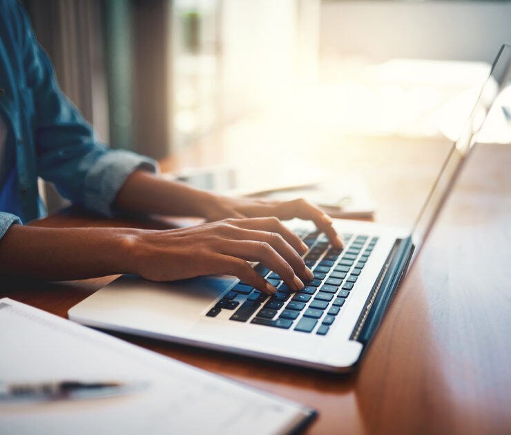 Person typing at a laptop