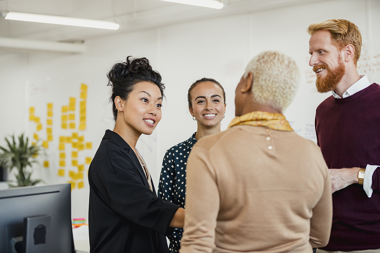 Group of coworkers talking and smiling