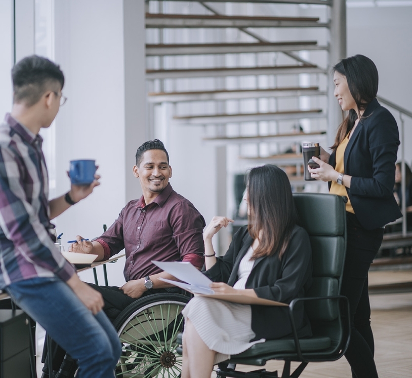 A group of peers talking and smiling at each other