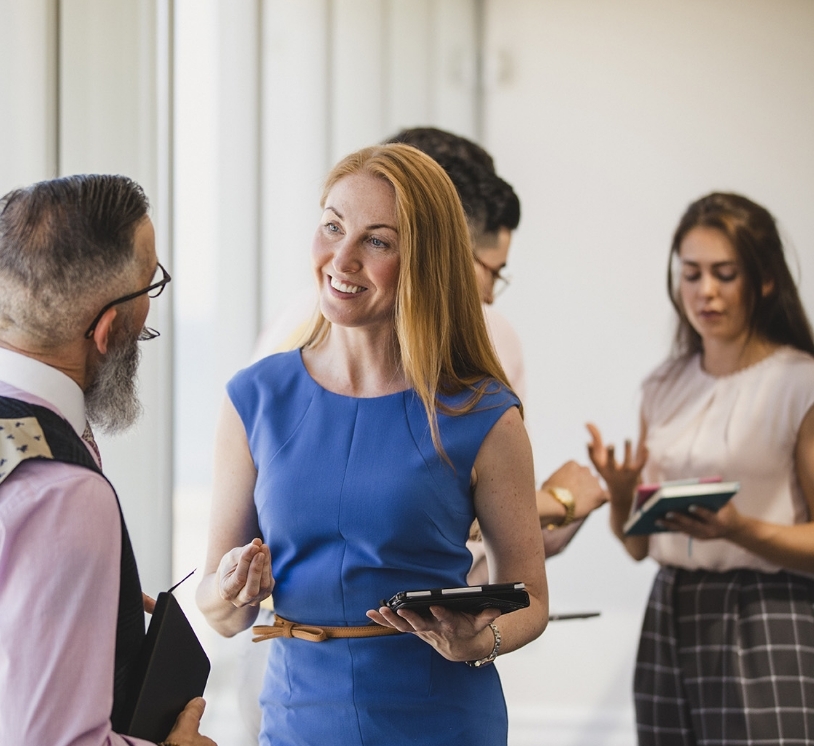 Woman talking and smiling at a coworker