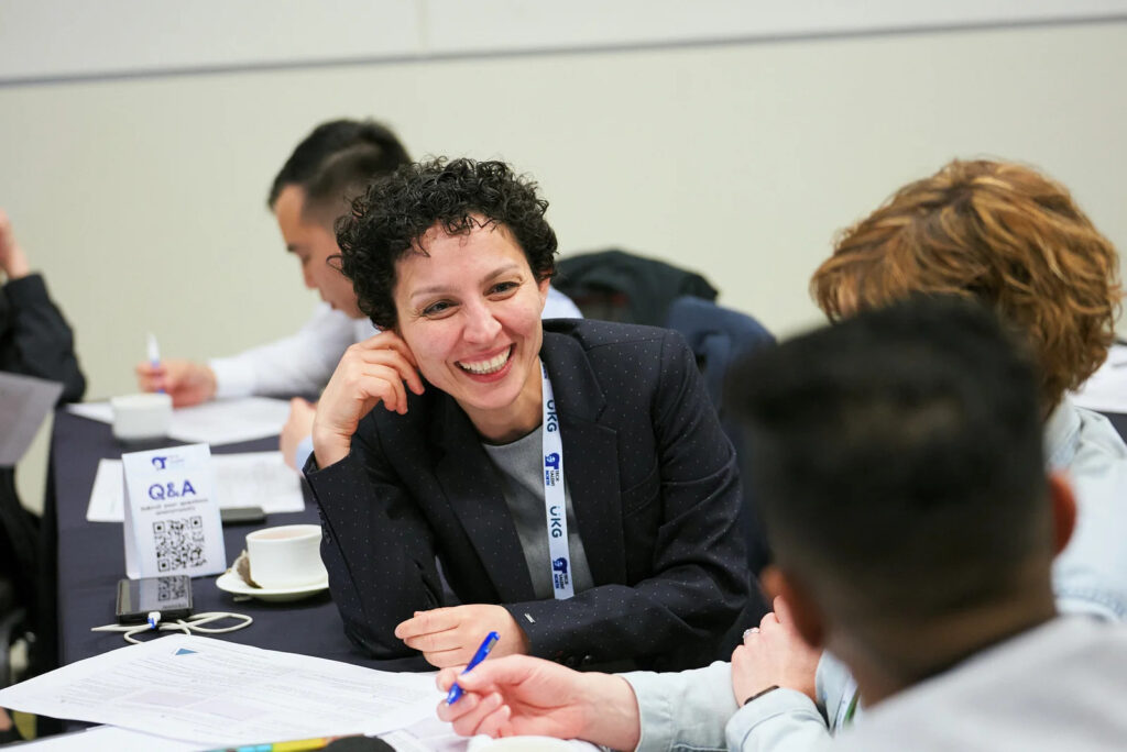 A woman smiling at a coworker