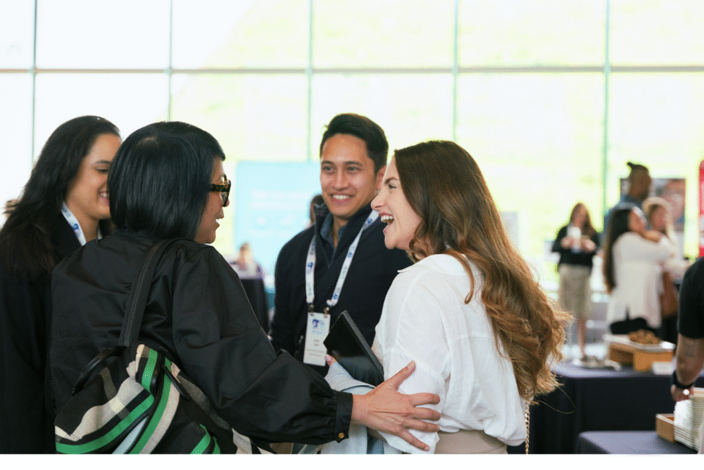 A group of peers talking and smiling