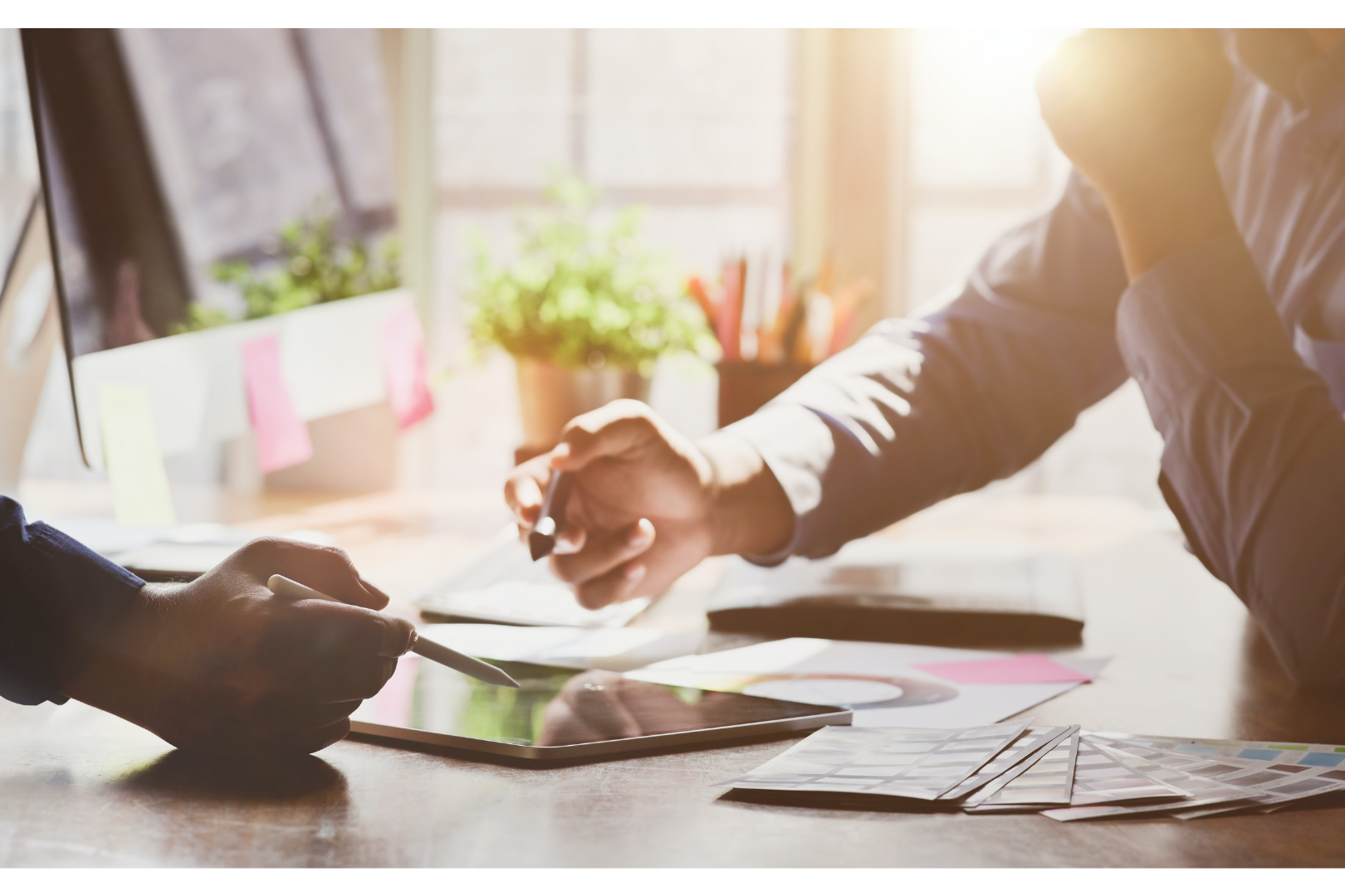 Two persons working on a tablet