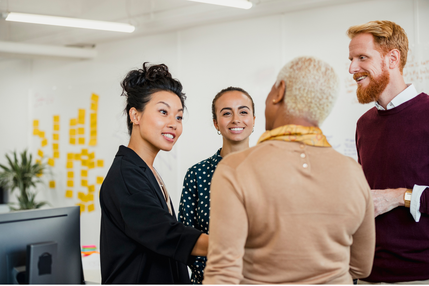 Group of coworkers talking and smiling