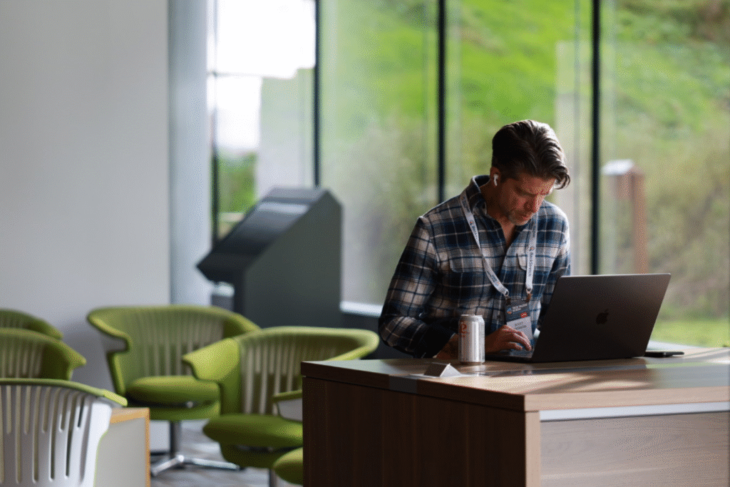a man working on a laptop, deep in concentration