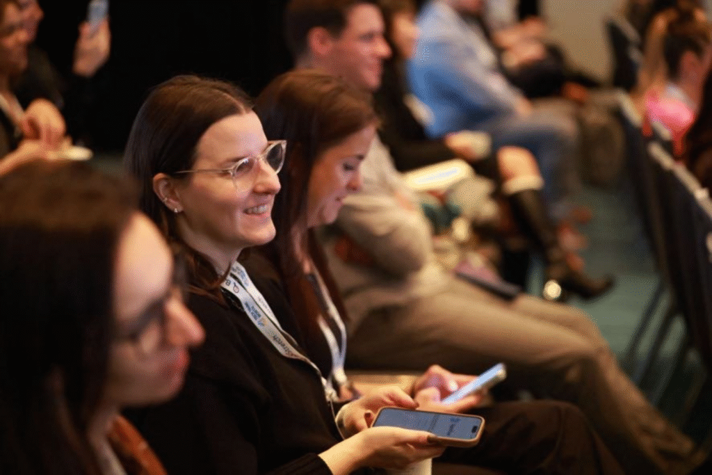 a close up of some people watching a presentation