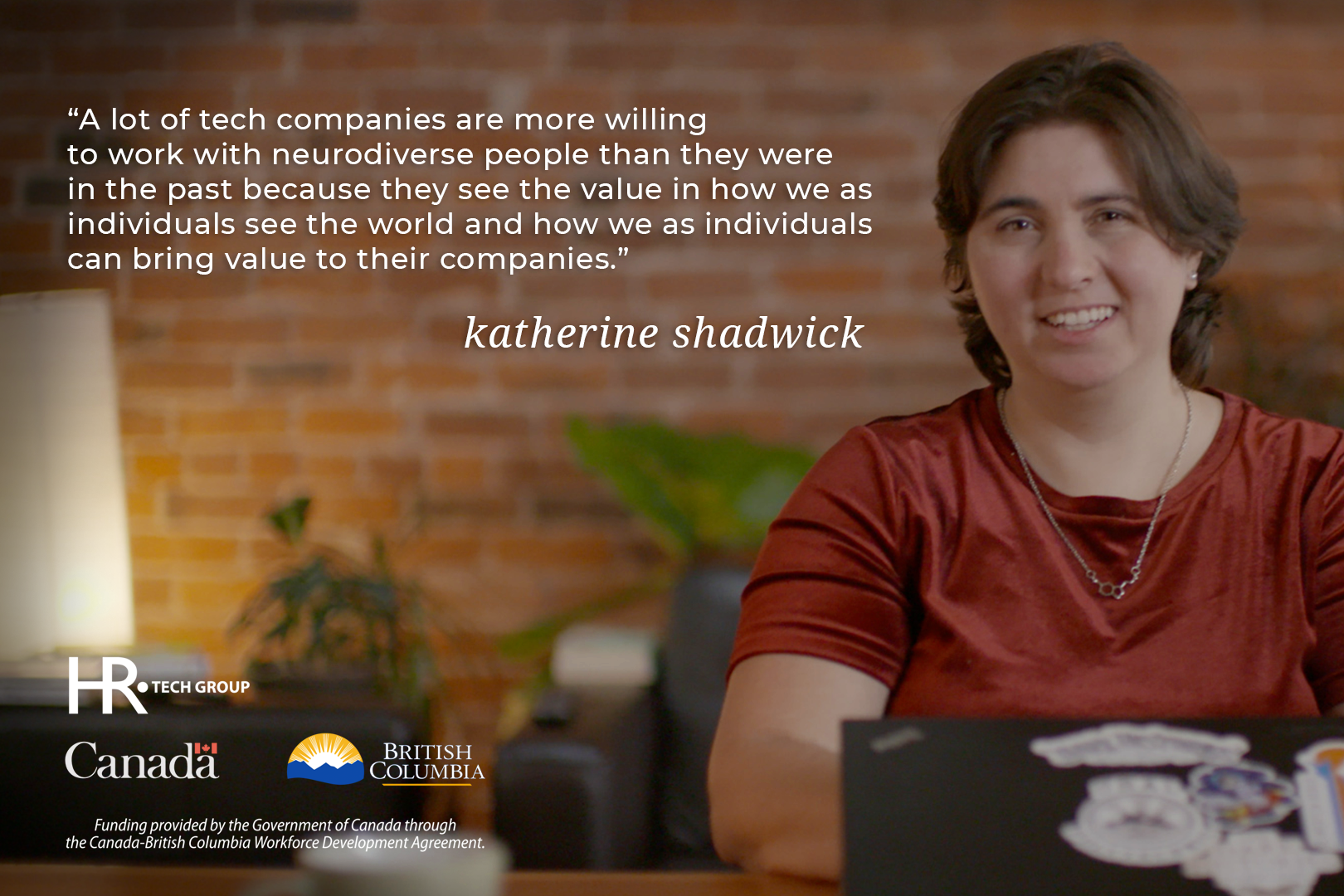 Woman sitting and smiling. "A lot of tech companies are more willing to work with neurodiverse people than they were in the past because they see value in how we as individuals see the world and how we as individuals can bring value to their companies." Katherine Chadwick