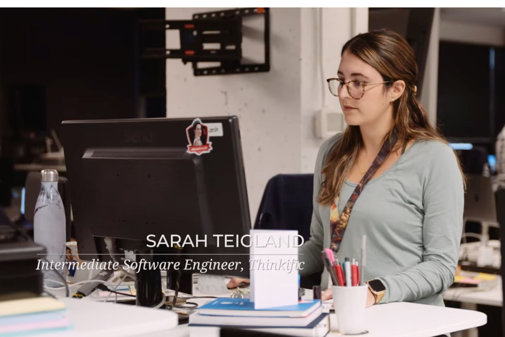 Woman working at a computer. Sarah Tiegland. Intermediate Software Developer, Thinkific
