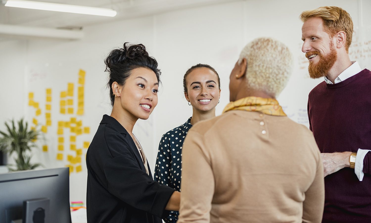 Group of coworkers talking and smiling