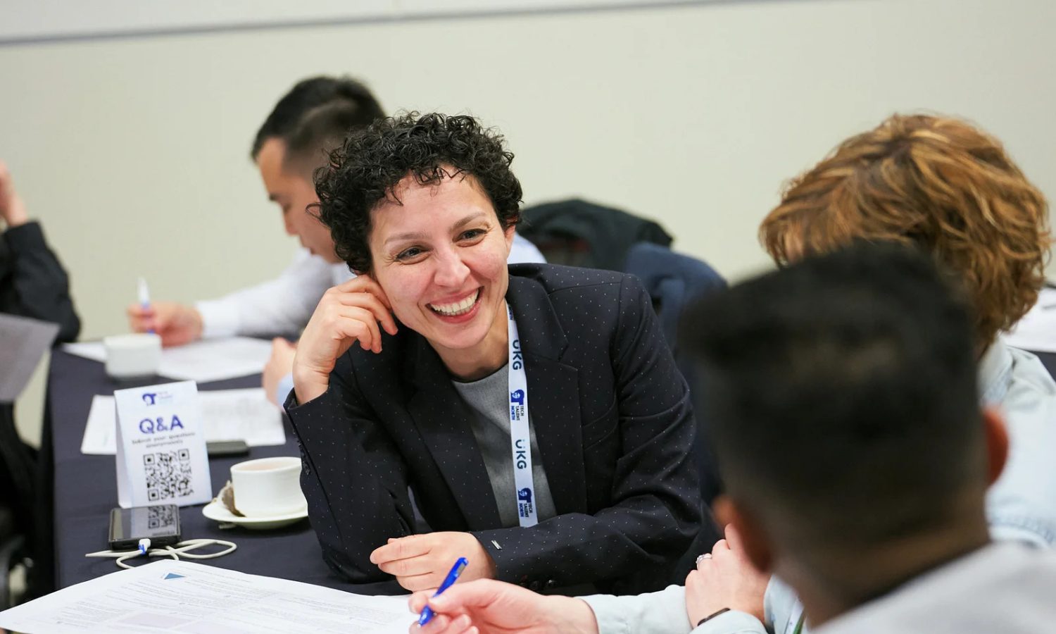 A woman smiling at a coworker