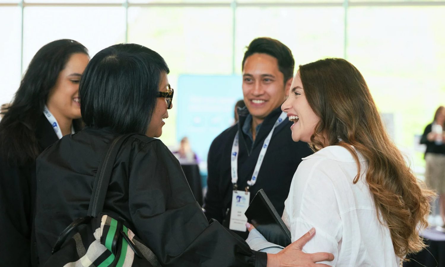 A group of peers talking and smiling